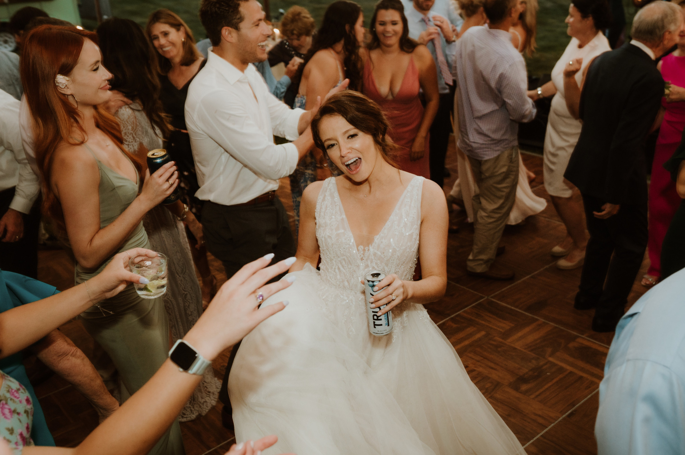 Bride dancing joyfully at River Road Farm wedding reception in Manchester, Vermont.