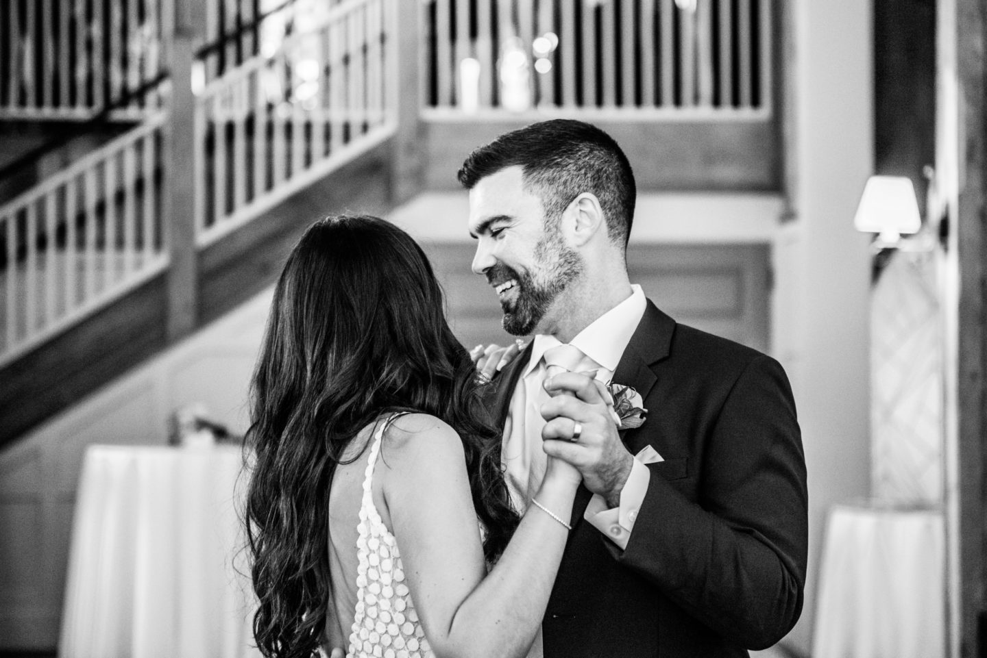 Bride and groom share joyful first dance at rustic Barn at Gibbet Hill wedding.