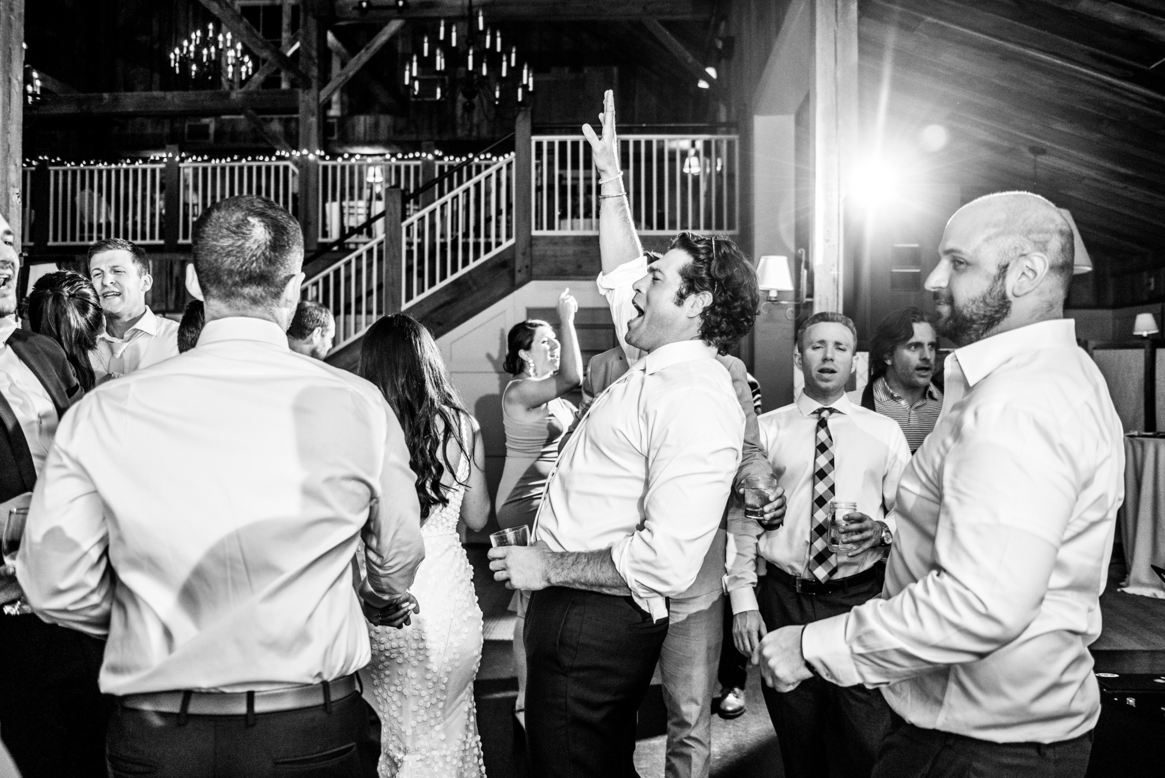 Guests dancing and celebrating at a joyful rustic barn wedding at The Barn at Gibbet Hill.