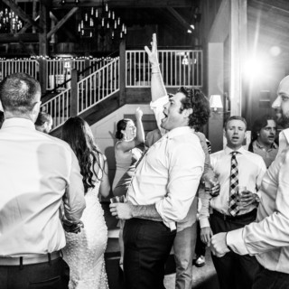 Guests dancing and celebrating at a joyful rustic barn wedding at The Barn at Gibbet Hill.