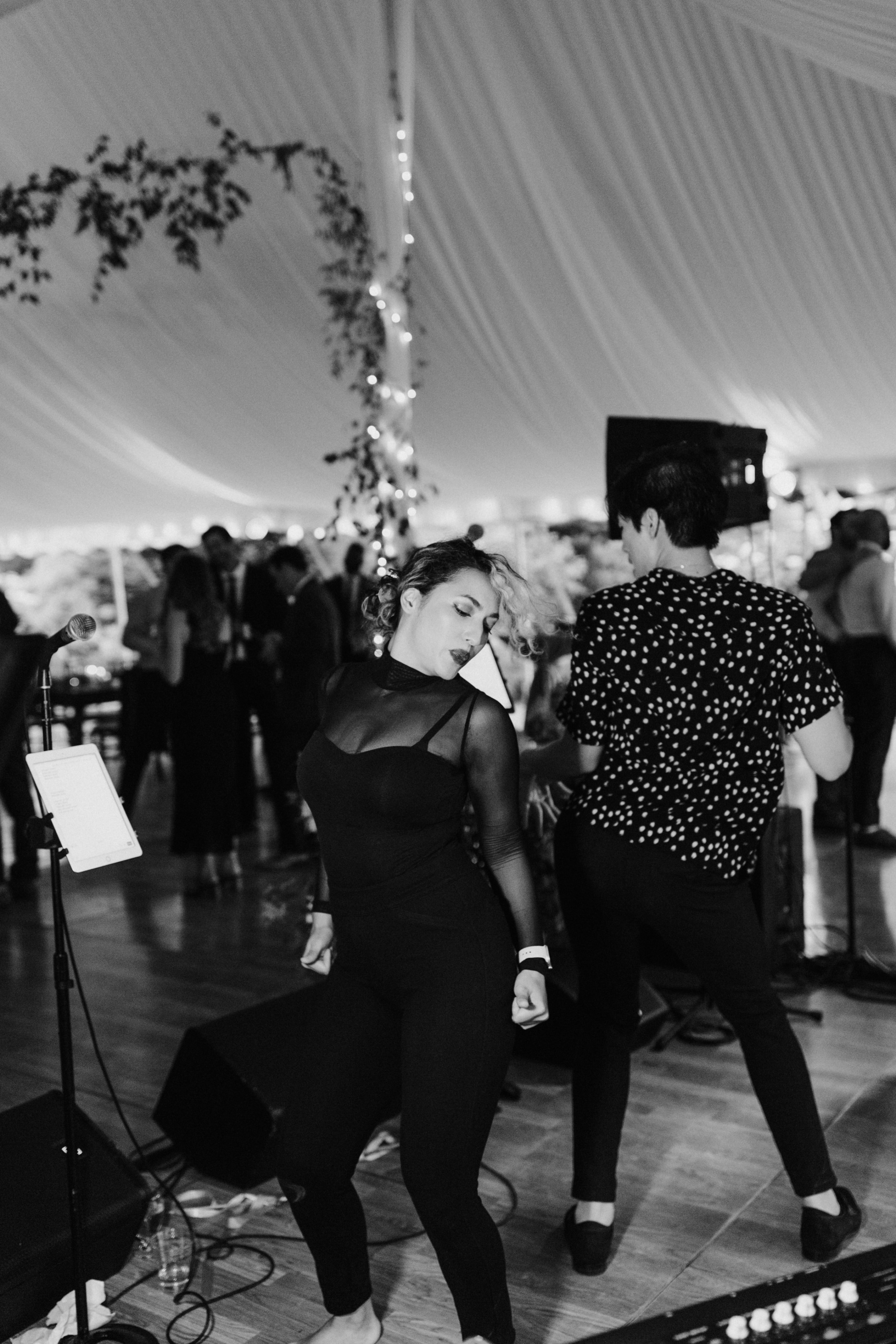 Woman dancing energetically under wedding tent lights at Topnotch Resort in Stowe, Vermont.