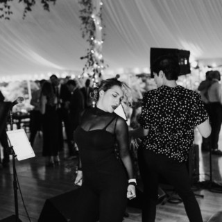 Woman dancing energetically under wedding tent lights at Topnotch Resort in Stowe, Vermont.