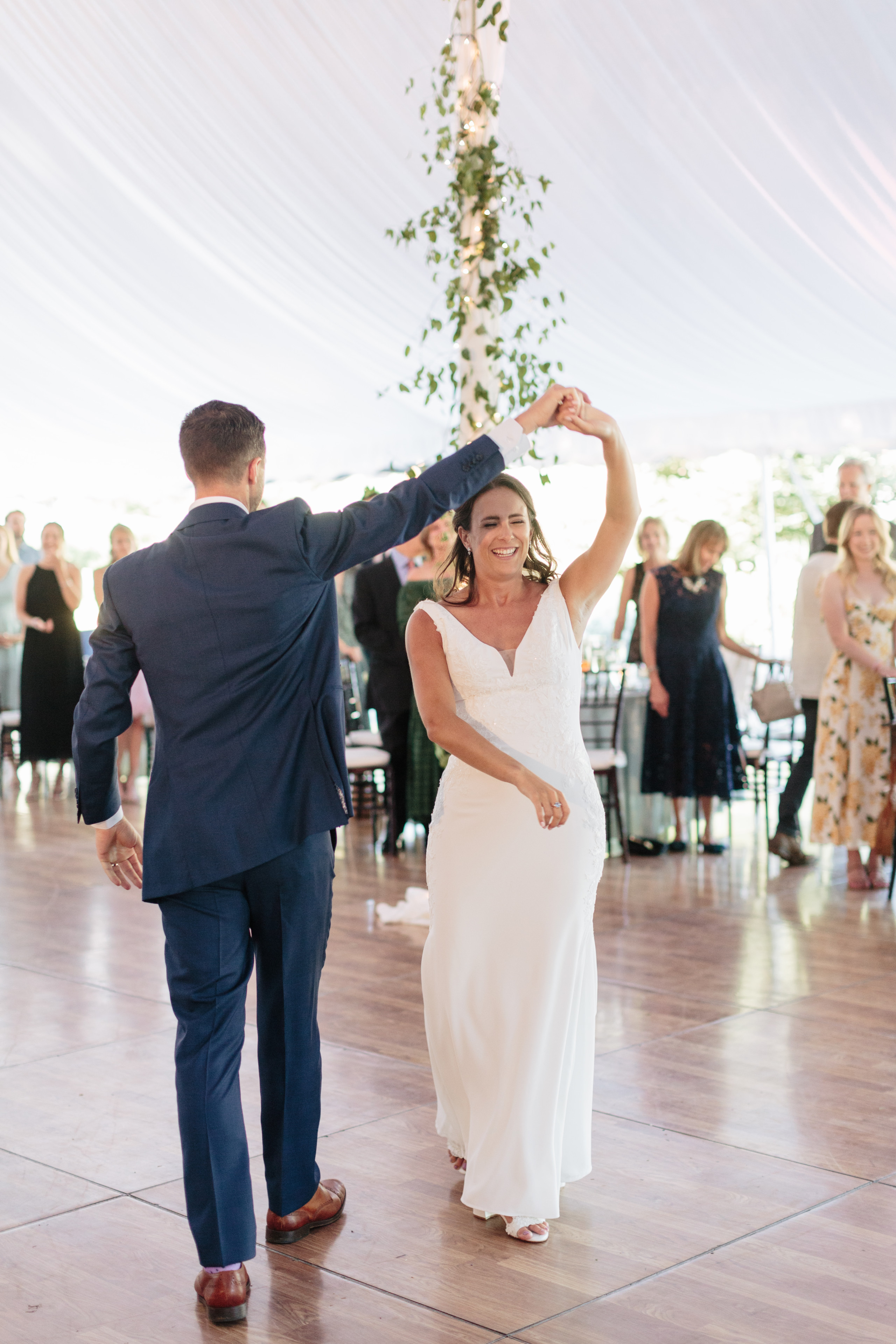 Bride and groom share their first dance under twinkling lights at Topnotch Resort wedding.