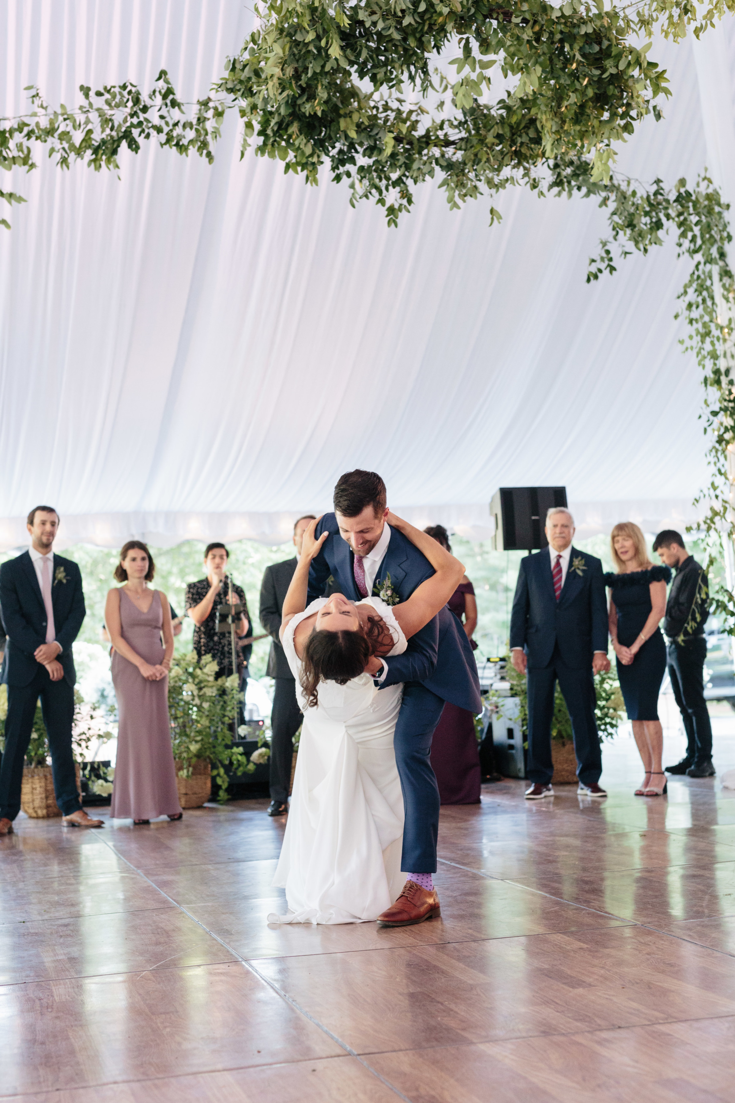 Bride and groom share a romantic first dance under elegant greenery at Topnotch Resort wedding.