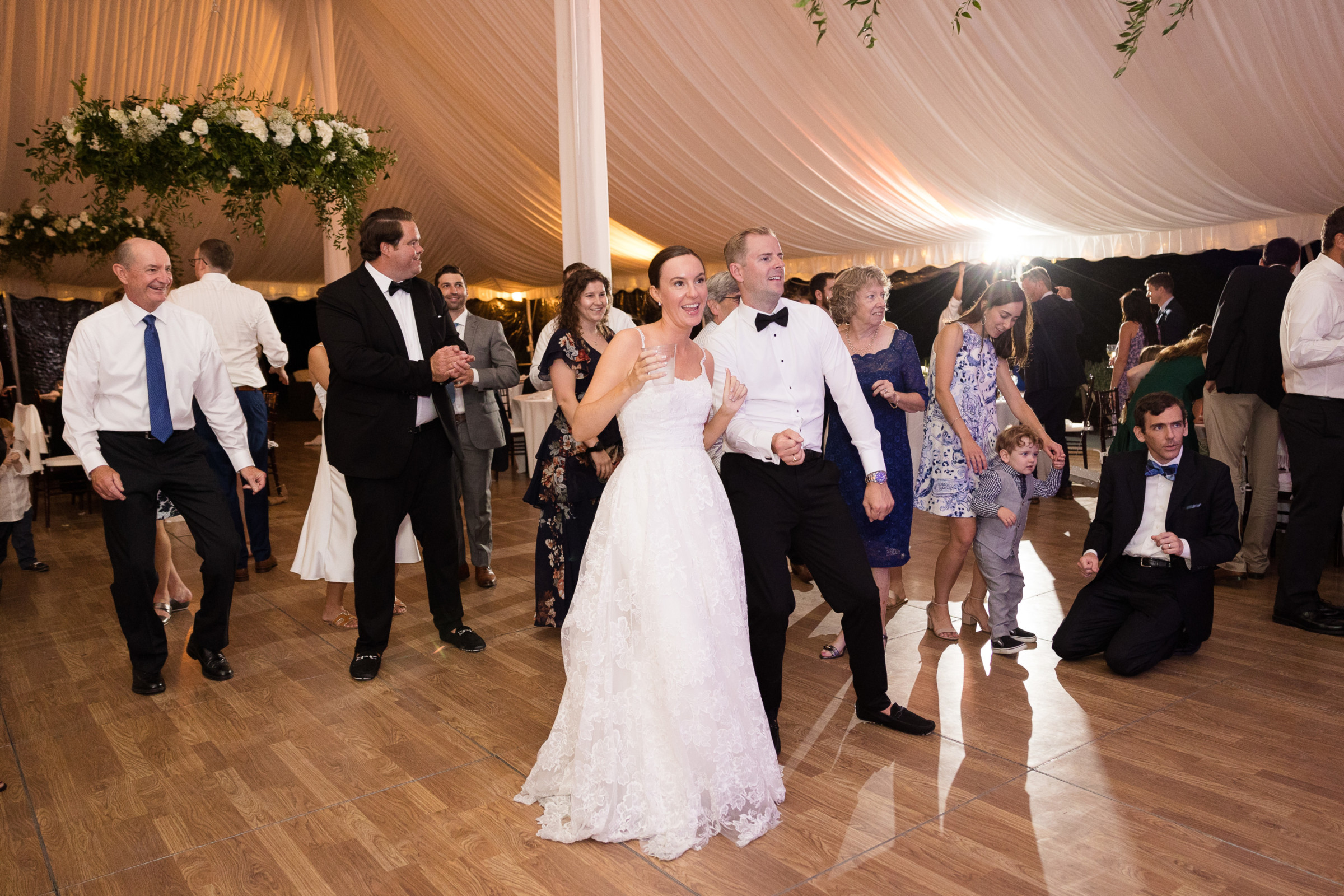 Bride and groom dancing joyfully at elegant Topnotch Resort wedding in Stowe, Vermont.