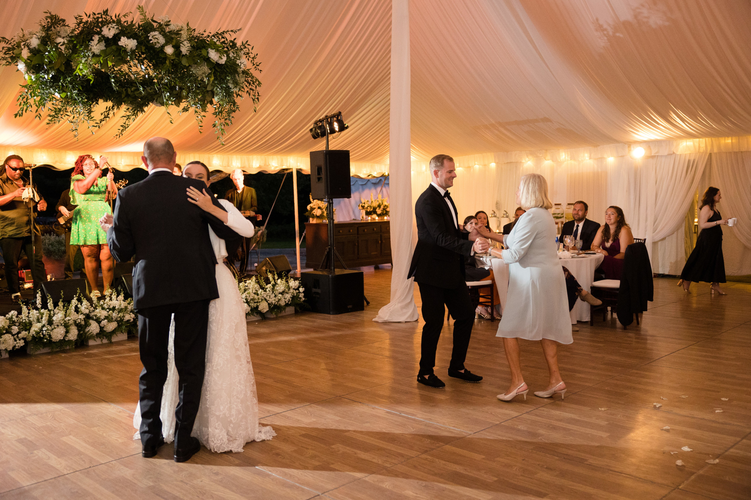 Bride and groom share family dances under elegant tent at Topnotch Resort in Stowe, Vermont.
