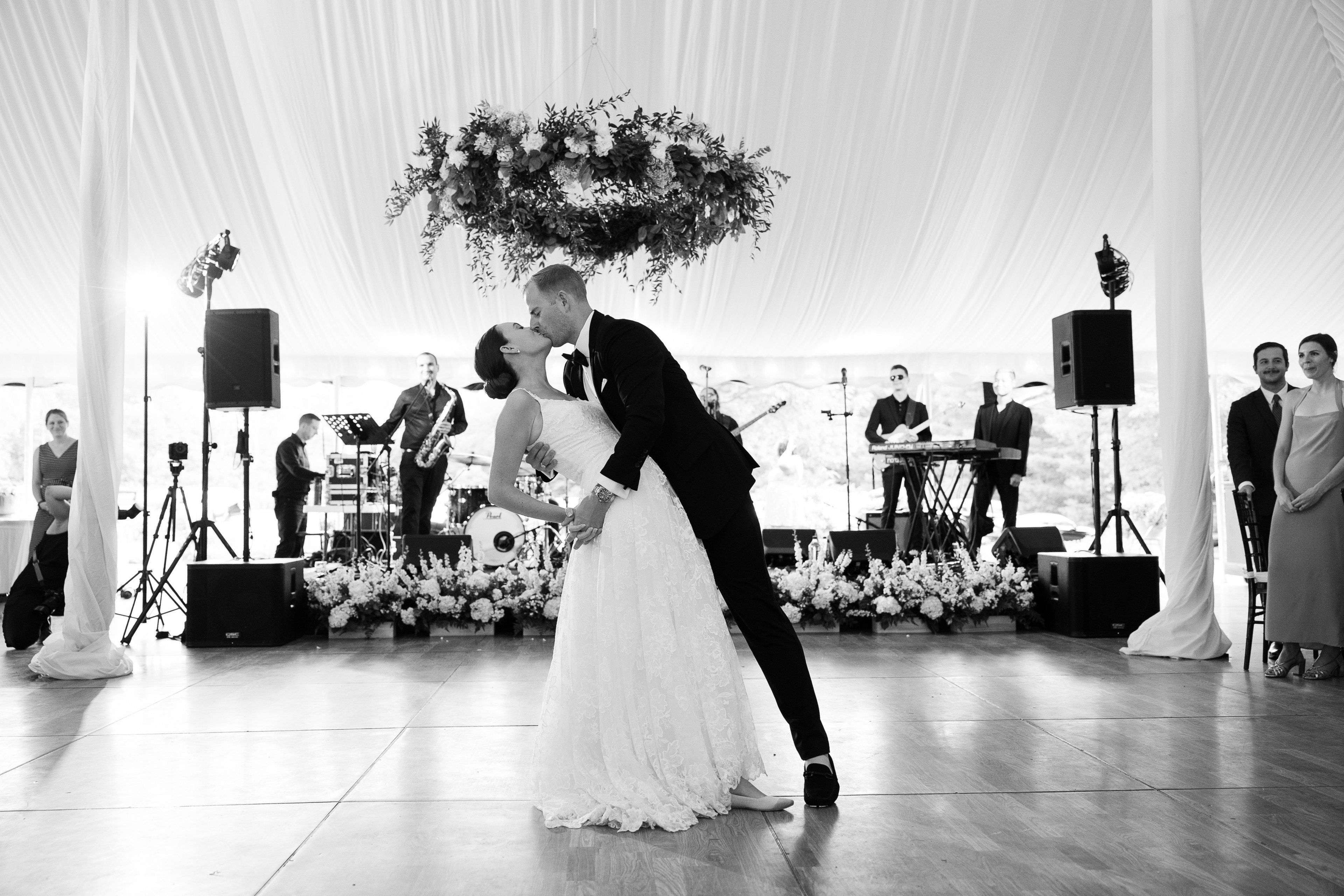 Bride and groom share a romantic first dance under elegant draped tent at Vermont wedding.