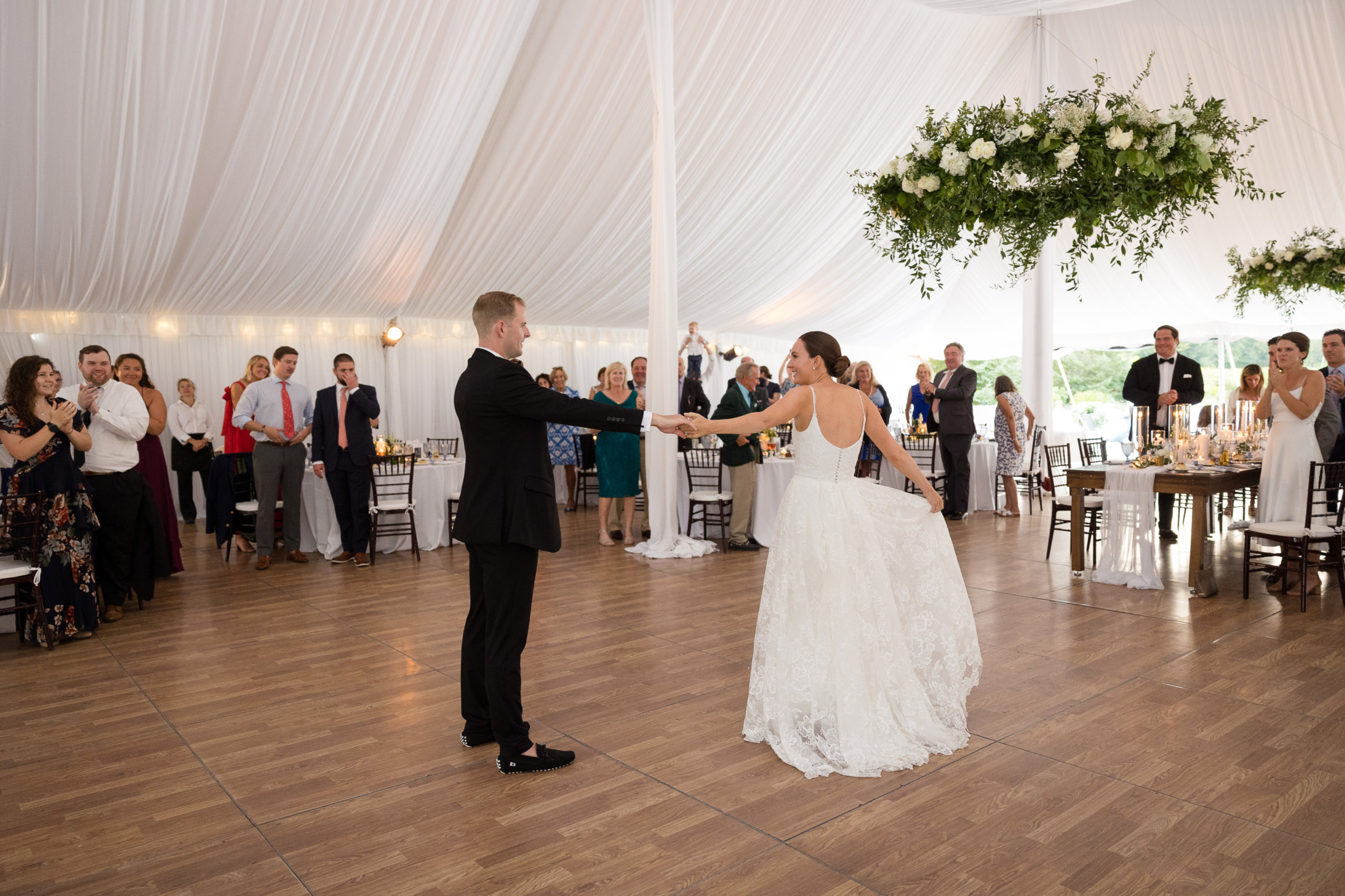 Bride and groom share their first dance under elegant white tent at Stowe Vermont wedding.