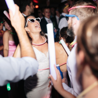 Bride dancing with glow sticks and guests at vibrant Topnotch Resort wedding reception in Stowe Vermont
