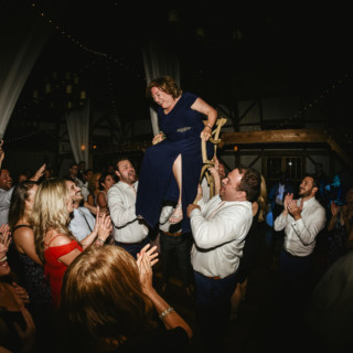 Bride lifted during joyful hora dance at rustic Valley View Farm wedding in Haydenville, Massachusetts.