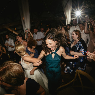 Bride dancing joyfully with guest at rustic Valley View Farm wedding in Haydenville, Massachusetts.