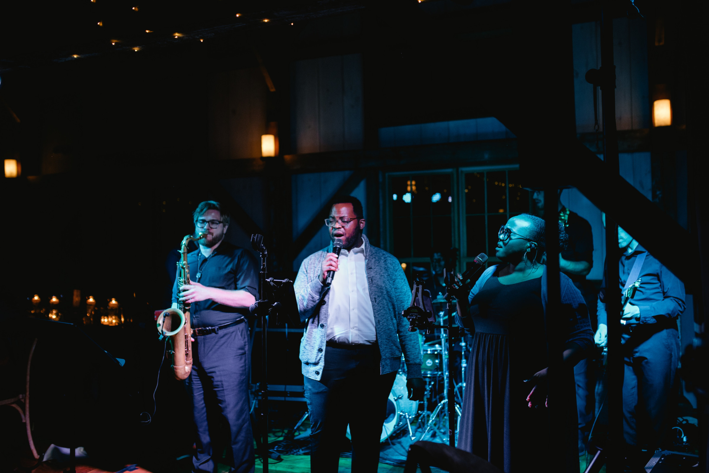 Live jazz band performing in a rustic indoor venue with warm lighting and soulful atmosphere.