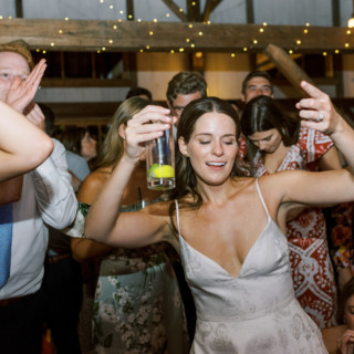 Joyful guests dancing under string lights at Valley View Farm wedding in Haydenville, Massachusetts.
