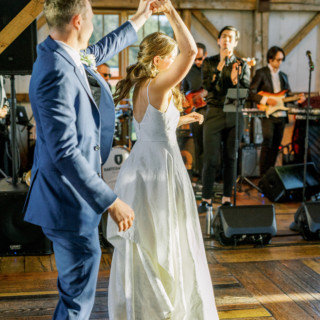 Bride and groom dancing at rustic Valley View Farm wedding in warm golden sunlight.