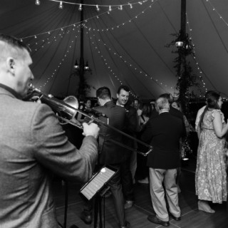 Black and white wedding reception with live jazz band under string lights at Willowdale Estate.