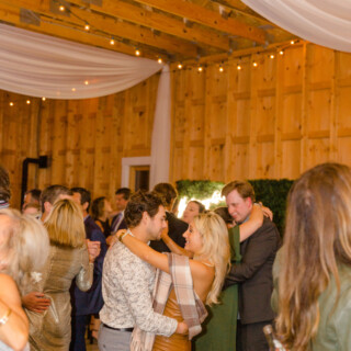 Couple dancing at rustic barn wedding with string lights at Autumn Lane Estate in Maine.
