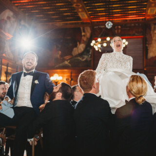Bride and groom lifted during the Hora dance at elegant Boston Public Library wedding.