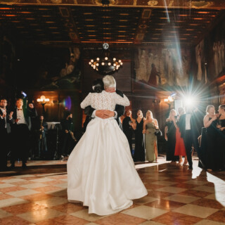 Newlyweds share a romantic first dance at the elegant Boston Public Library wedding reception.