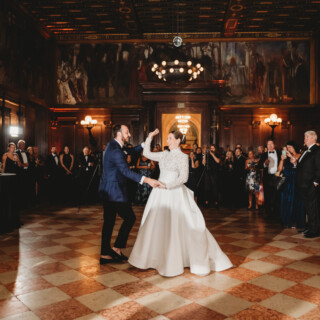 Bride and groom share first dance in elegant Boston Public Library ballroom wedding.