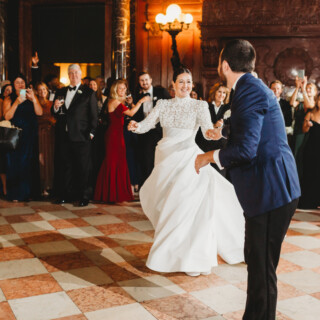 Bride and groom share a joyful first dance at elegant Boston Public Library wedding.