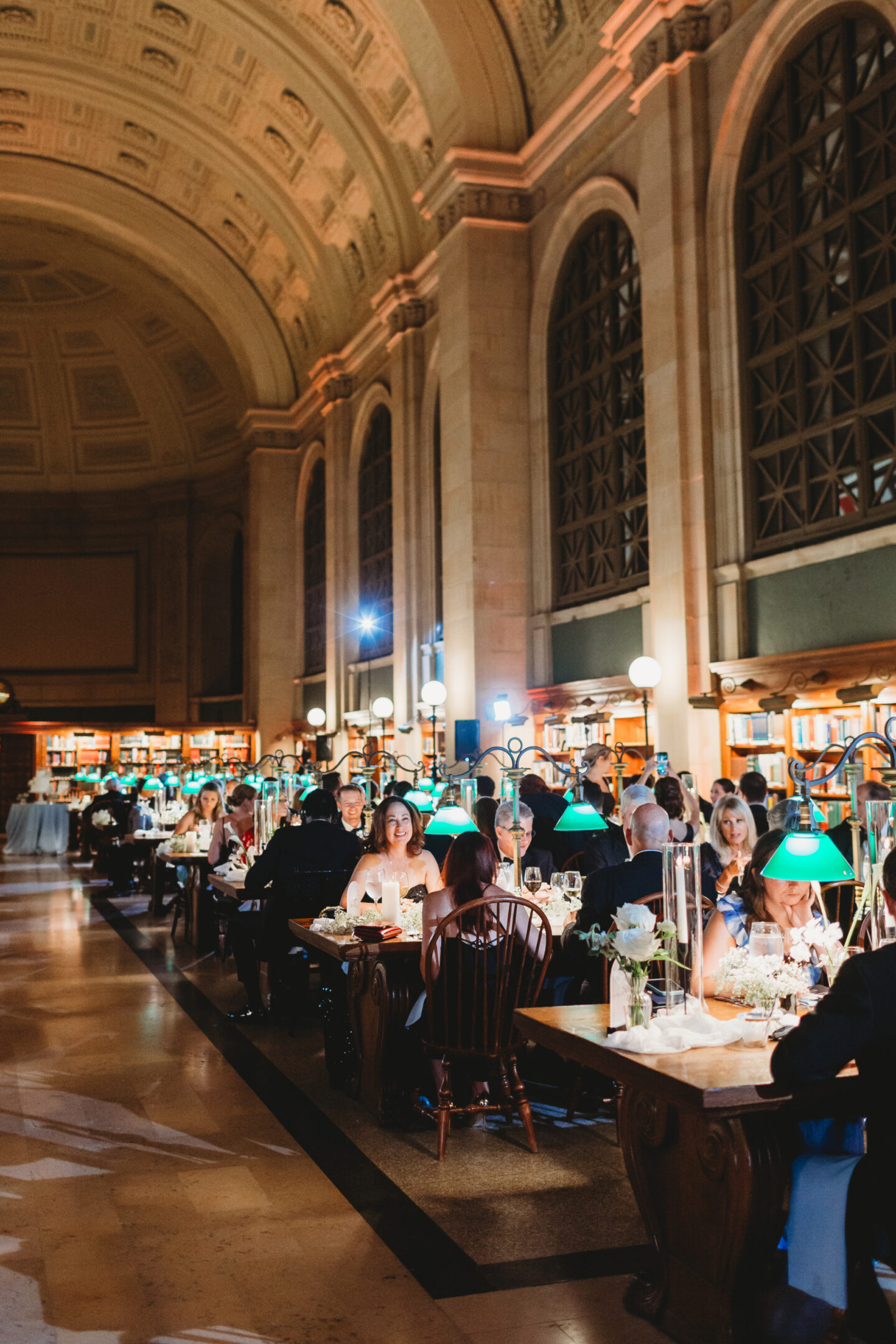 Elegant wedding dinner beneath grand vaulted ceilings at the historic Boston Public Library.