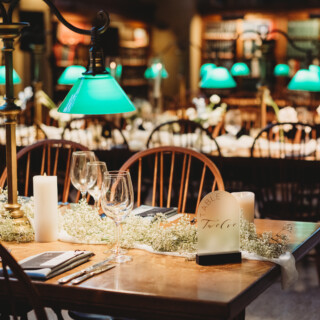 Elegant wedding reception table with candles and flowers inside the Boston Public Library.