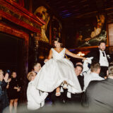 Bride and groom lifted during joyful Hora dance at elegant Boston Public Library wedding.