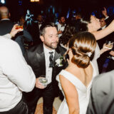 Bride and groom celebrating with guests at Boston Public Library wedding reception.