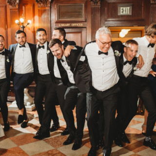 Bride and guests dancing joyfully in elegant Boston Public Library wedding celebration.