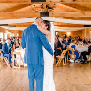 Bride and groom sharing their first dance at rustic Vermont wedding reception.