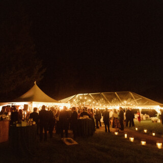 Romantic outdoor wedding reception with glowing string lights at Yellowstone Club in Big Sky, Montana.