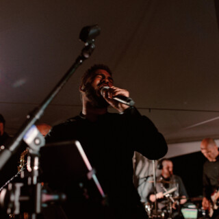 Soulful live band performing under warm tent lights at Yellowstone Club wedding in Big Sky, Montana.