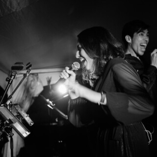 Black-and-white photo of passionate singers performing live at a Yellowstone Club wedding in Montana.