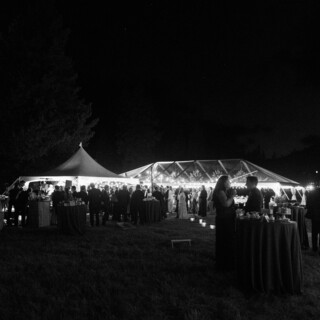 Elegant nighttime wedding reception under a glowing tent in Big Sky, Montana.