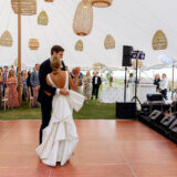 Bride and groom share romantic first dance under elegant white tent at Nantucket wedding.