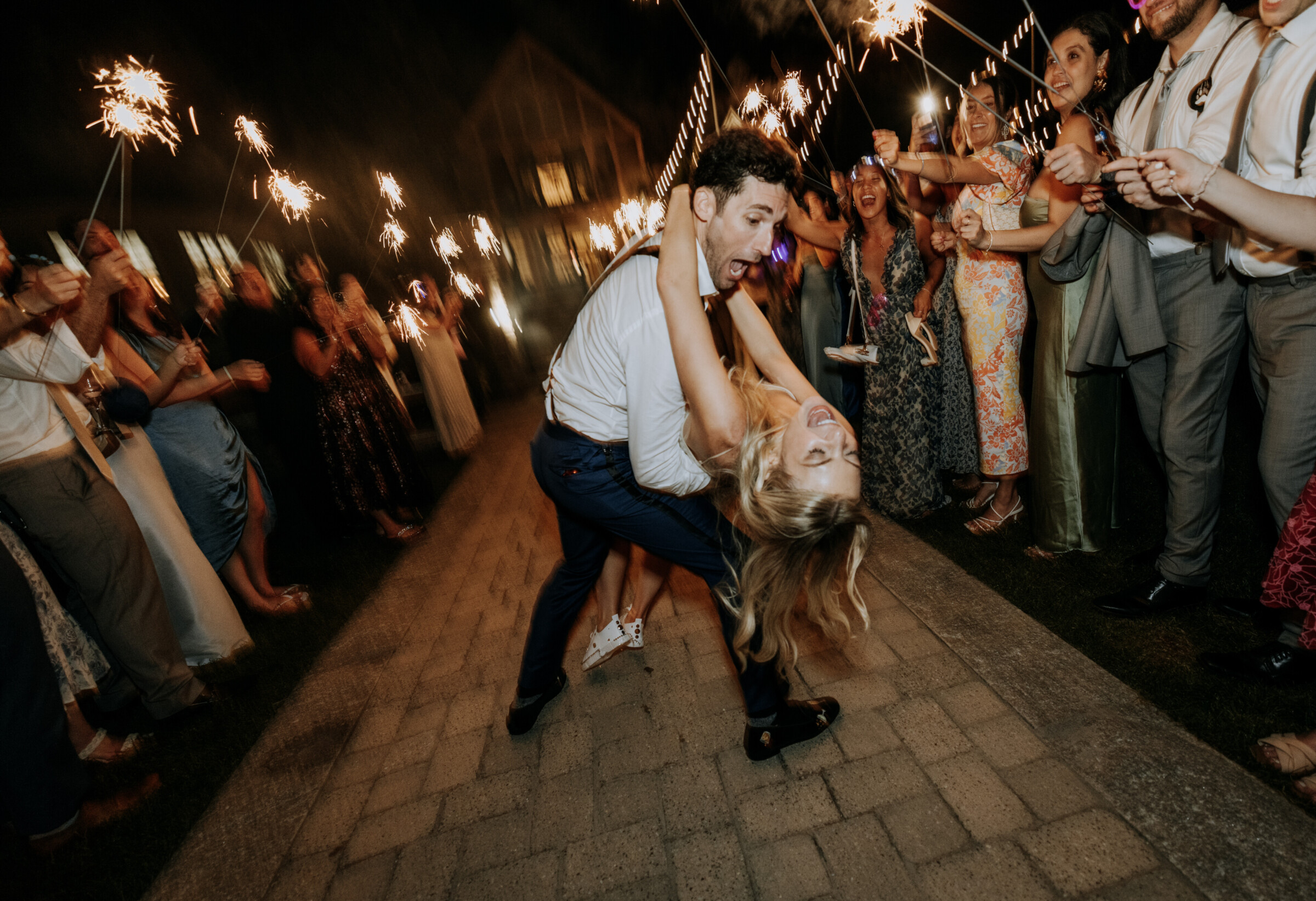 Bride and groom dancing under sparklers at Bar Harbor wedding celebration.