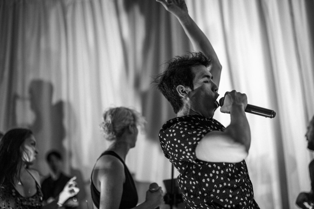Energetic black-and-white photo of passionate singers performing live at a wedding in Bar Harbor.