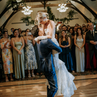 Bride and groom share a joyful dance surrounded by cheering guests at Bar Harbor Club wedding.