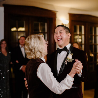 Mother and son laughing while dancing at a joyful French’s Point wedding in Maine.