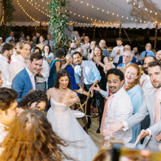 Bride and groom dancing under fairy lights at joyful Mount Hope Farm wedding in Bristol, Rhode Island.