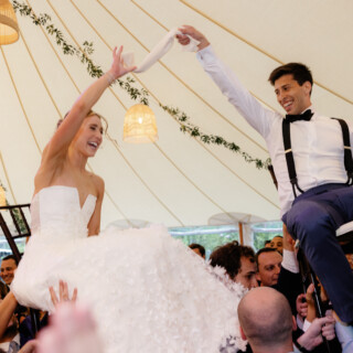Bride and groom lifted during joyful Hora dance at Willowdale Estate wedding in Topsfield, Massachusetts.