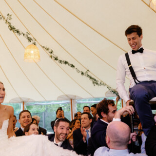 Bride and groom lifted during joyful Horah dance at Willowdale Estate wedding in Topsfield MA.