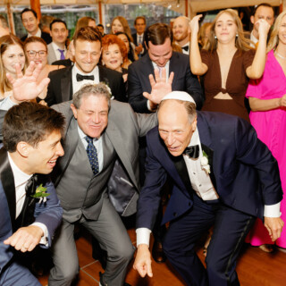 Guests celebrate joyfully during an elegant wedding at Willowdale Estate in Topsfield, Massachusetts.