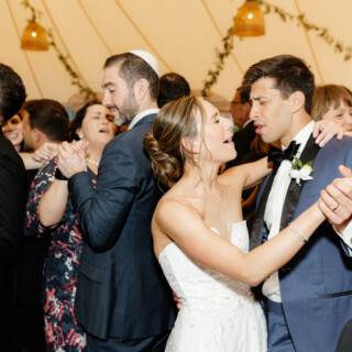 Bride and groom dancing joyfully at Willowdale Estate wedding in Topsfield, Massachusetts.