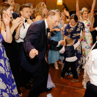 Older man dancing joyfully with guests at Willowdale Estate wedding in Topsfield, Massachusetts.