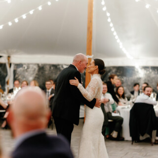 Bride and father share emotional dance under string lights at Bradley Estate wedding in Canton.
