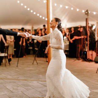 Bride and groom share a romantic first dance under string lights at Bradley Estate wedding.