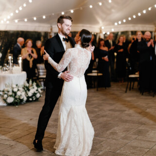 Bride and groom share a romantic first dance under glowing lights at Bradley Estate wedding.