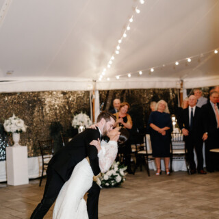 Bride and groom share a romantic first dance under string lights at Bradley Estate wedding.