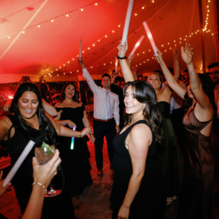 Guests dancing under warm string lights at a joyful Bradley Estate wedding reception in Canton.